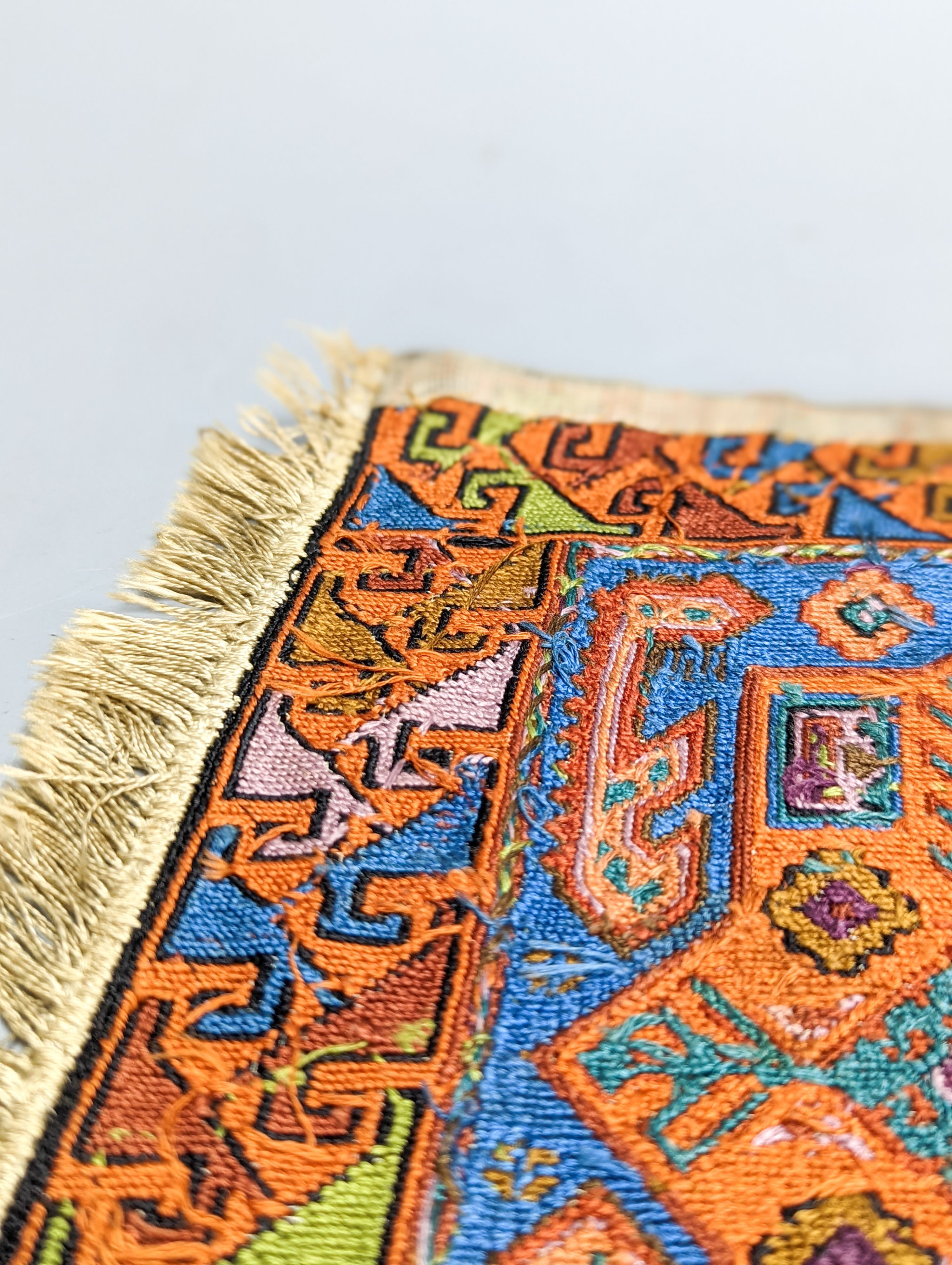 A Caucasian style petit point miniature rug 33x20cm